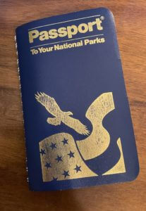 Blue Passport to your national Park book on wood table