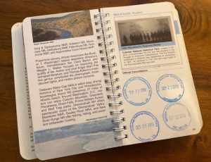 Open classic passport to your national park book with stamps
