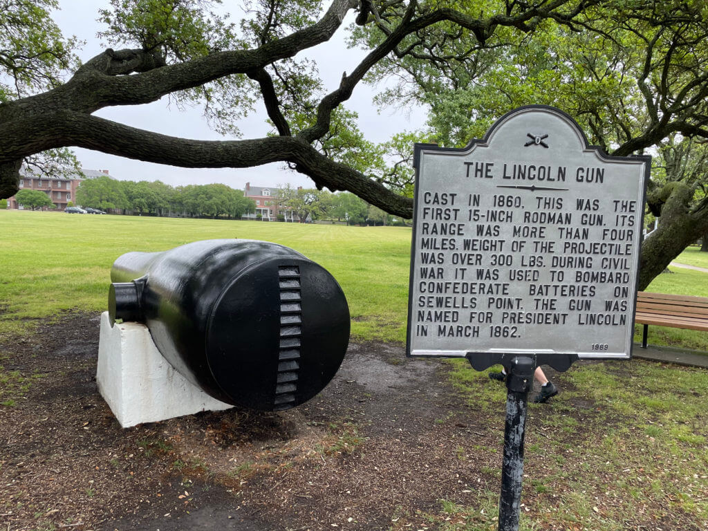 The Lincoln Gun sign and back of Lincoln gun next to tree