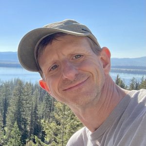 Headshot of a handsome man in a baseball hat