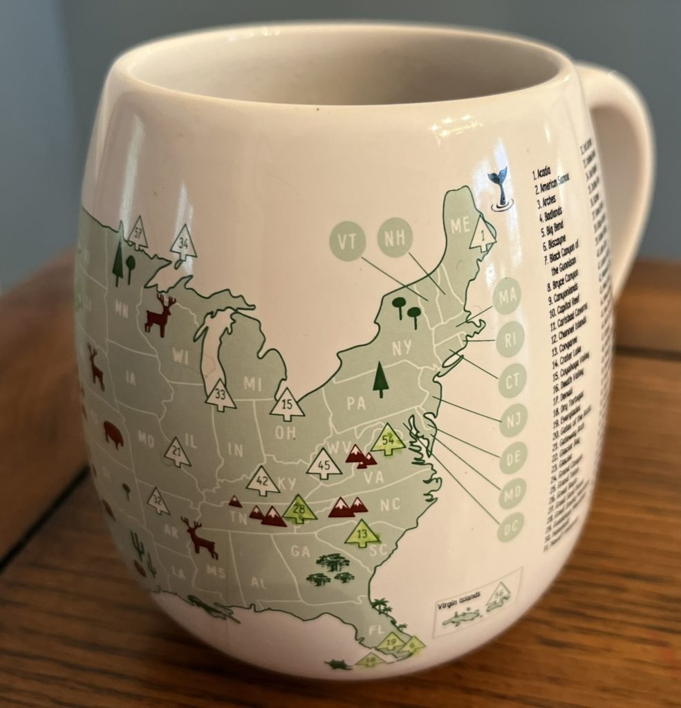Close up of a coffee mug with the US map highlighting the National Parks 