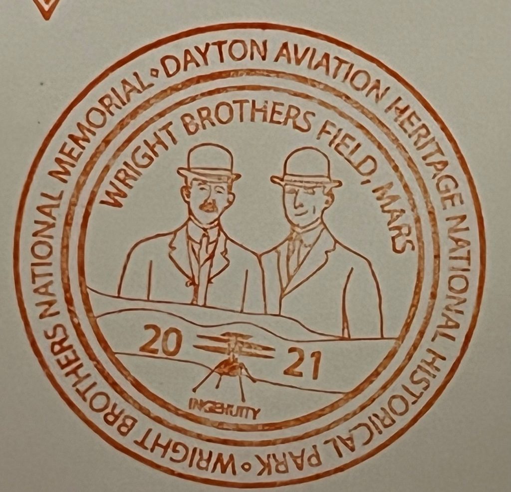 National Park passport stamps including Wright Brothers Field, Mars Ingenuity 2021 in red