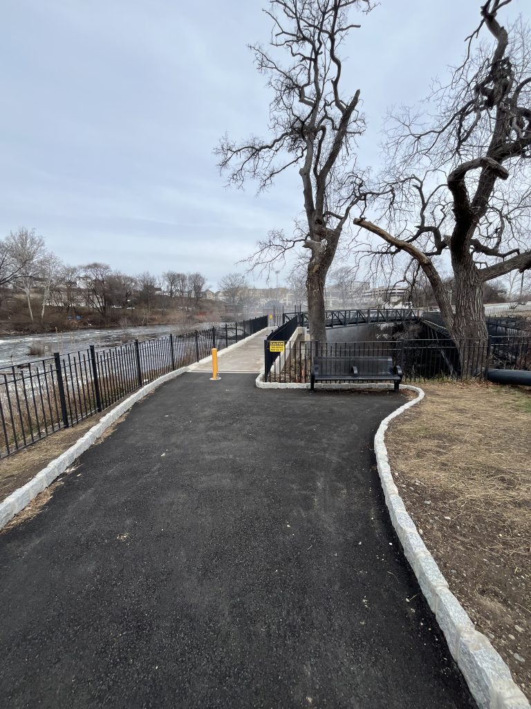 The paved overlook walkway at Paterson Great Falls NHP curving along the top of the Passaic River gorge.