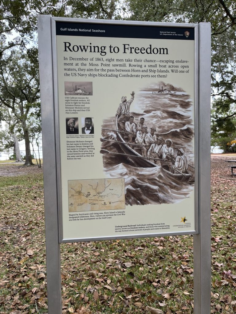 Gulf Islands National Seashore Visitor Center: Davis Bayou Guide 9 A sign providing information about the history of the area at Davis Bayou Area in Gulf Islands National Seashore.