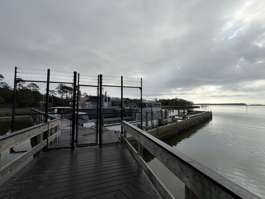 Gulf Islands National Seashore Visitor Center: Davis Bayou Guide 10 ooden pier extending over salt marsh at Gulf Islands National Seashore Davis Bayou Area.