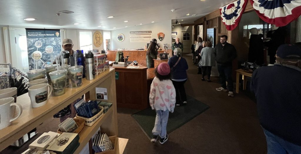 Interior of the James A. Garfield National Historic Site visitor center bookstore with visitors