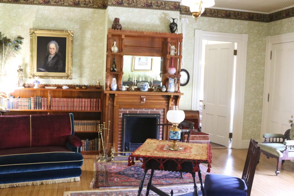 Parlor interior of Lawnfield with fireplace and portrait at James A. Garfield National Historic Site
