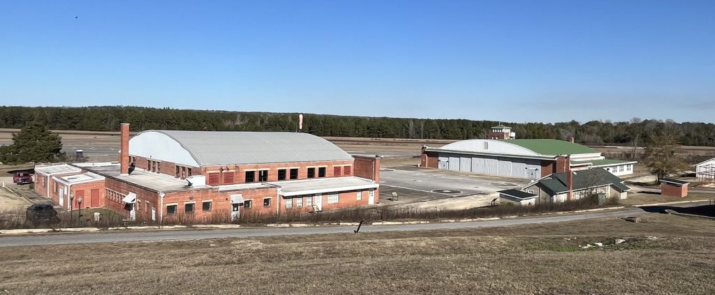 Wide view of Moton Field hangars and airfield at Tuskegee Airmen National Historic Site from the parking area overlook