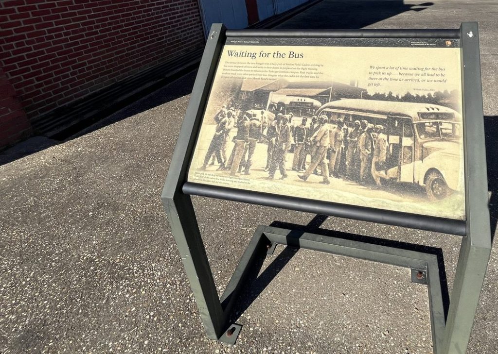 Waiting for the Bus interpretive panel showing Tuskegee Airmen cadets at Moton Field Alabama