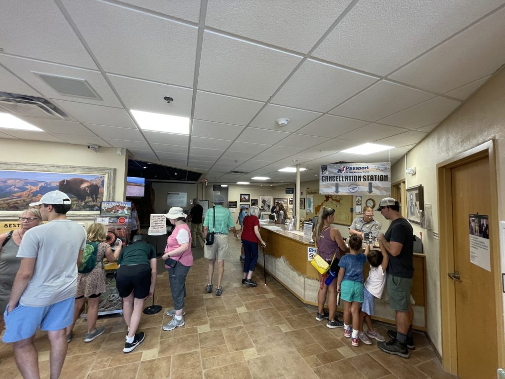 Busy at ranger desk inside Ben Reifel Visitor Center with visitors waiting