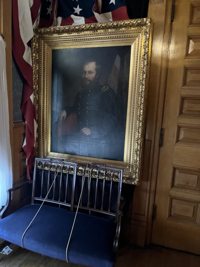 Close-up of a large oil portrait of James A. Garfield in military uniform at Lawnfield NHS