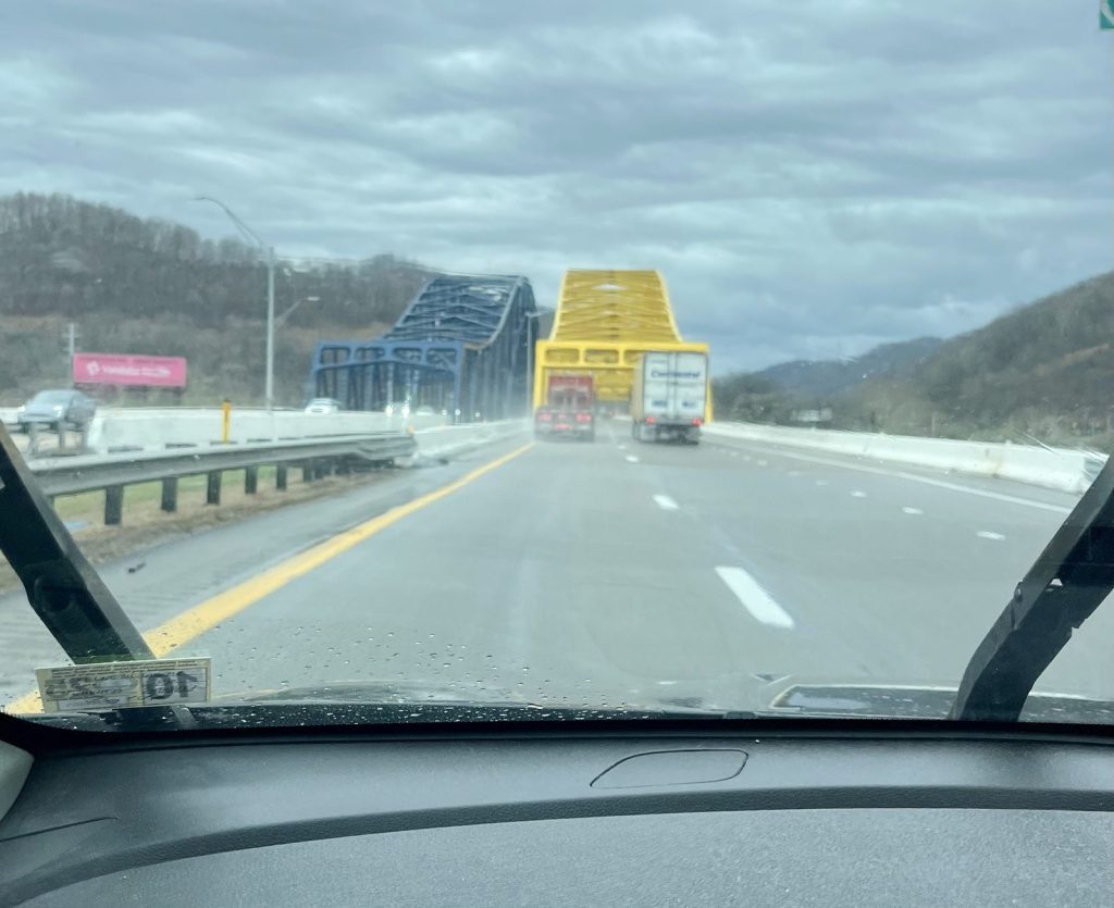 iew from inside car driving across a steel arch bridge on the highway near New River Gorge West Virginia