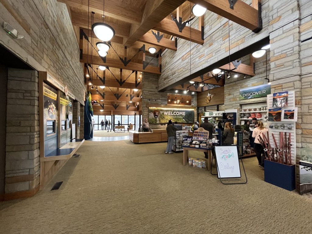 Exhibit hall interior at Canyon Rim Visitor Center New River Gorge with displays and welcome signage
