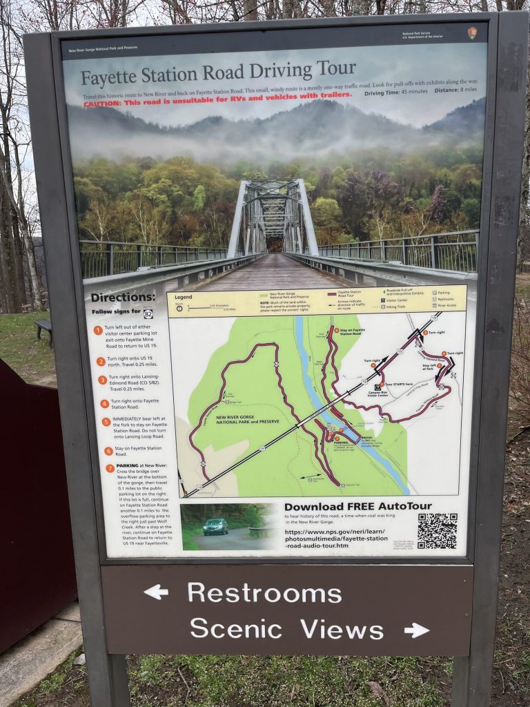 Fayette Station Road Driving Tour interpretive sign at New River Gorge National Park with restrooms and scenic views directional arrows 