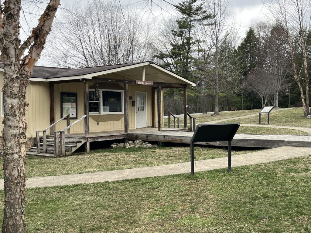 Small yellow Grandview contact station building at New River Gorge National Park with wooden ramp entrance
