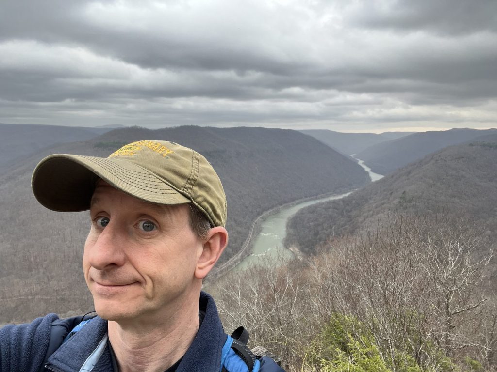 Visitor selfie at Grandview overlook with New River Gorge canyon and river visible in the background