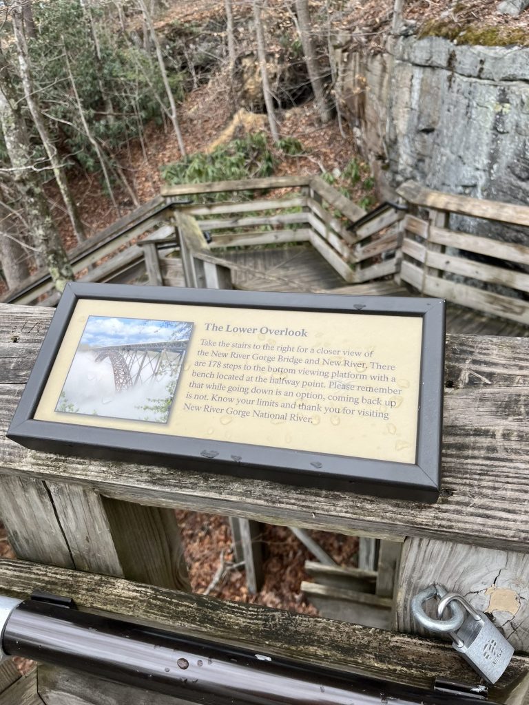 The Lower Overlook interpretive sign on wooden overlook deck at New River Gorge describing stairs to lower viewing platform