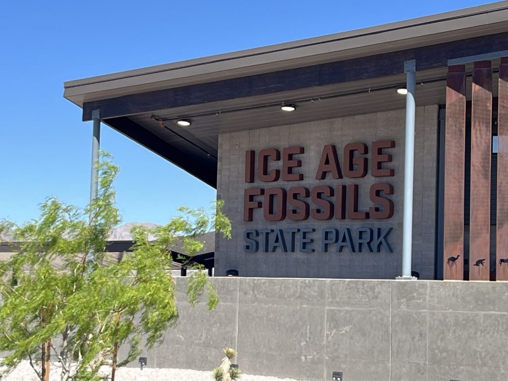 Exterior sign for Ice Age Fossils State Park in North Las Vegas Nevada with animal silhouettes on the building