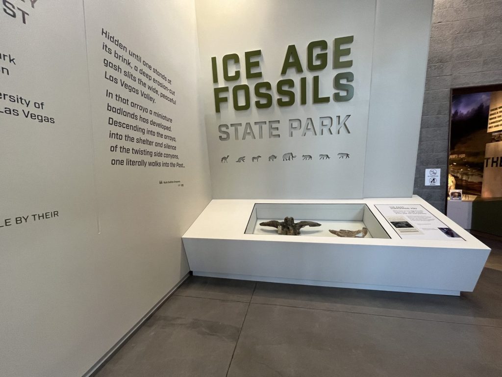 Interior of Ice Age Fossils State Park visitor center showing fossil display case and Ice Age Fossils State Park signage