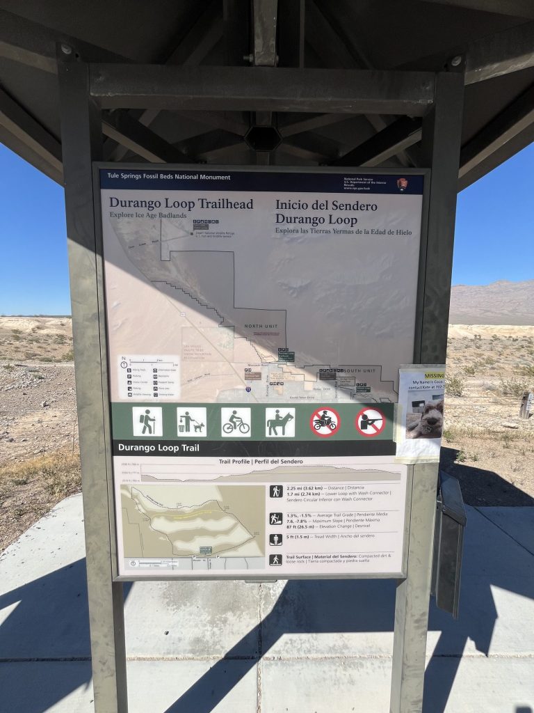 Durango Loop Trailhead bilingual sign showing trail map and distance information for Tule Springs Fossil Beds National Monument